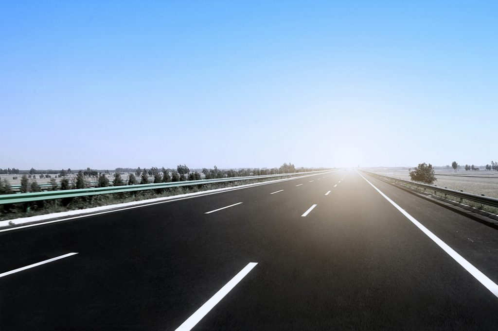 Long Distance Towing On Road With Sun In Horizon