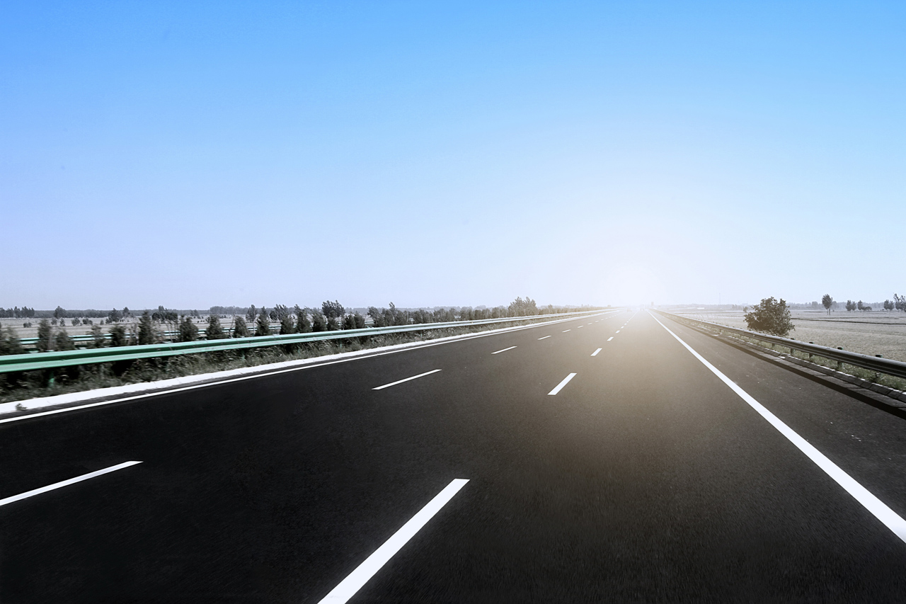 Long Distance Towing On Road With Sun In Horizon